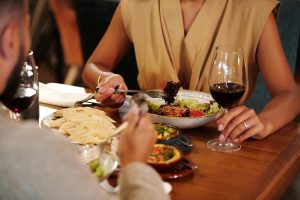 Couple eating food at dinner table